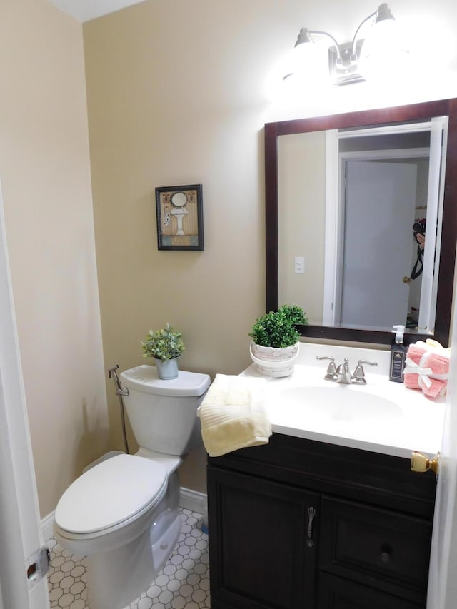 bathroom featuring vanity and toilet