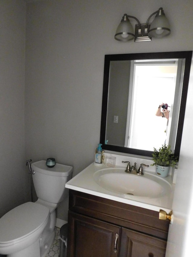 bathroom featuring vanity and toilet