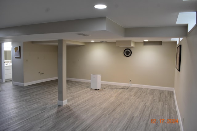 basement featuring hardwood / wood-style flooring and washer / clothes dryer