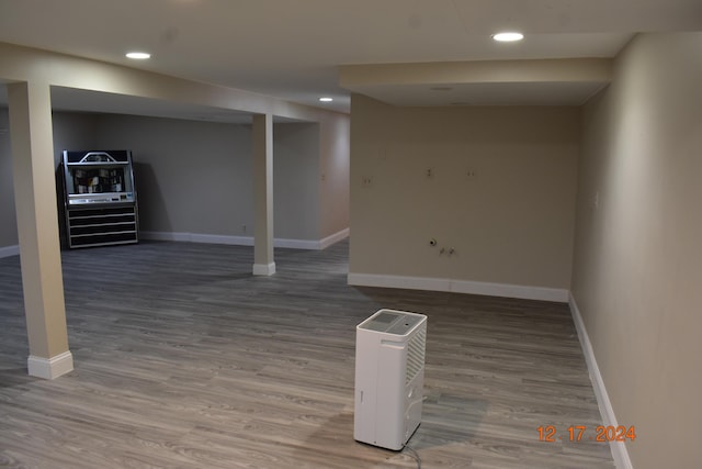 basement with hardwood / wood-style flooring