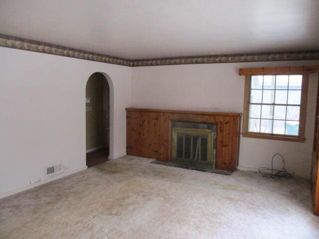 unfurnished living room with light carpet