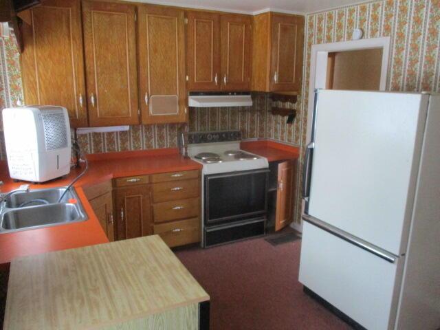 kitchen with sink and white appliances