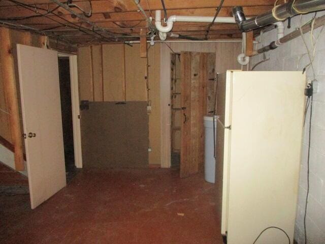 basement featuring white fridge