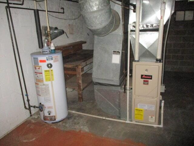 utility room with heating unit and gas water heater