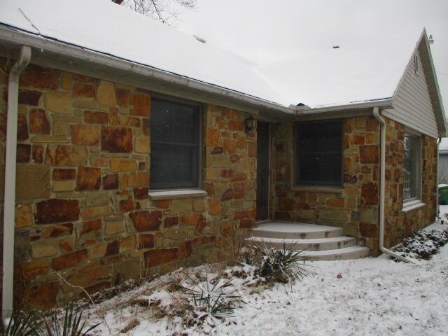 view of snow covered property entrance