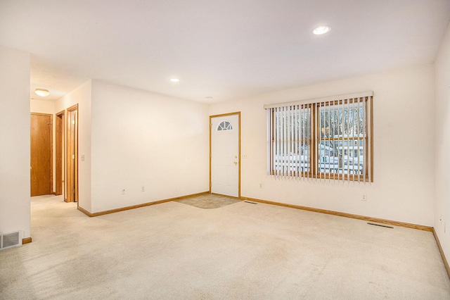 empty room featuring light colored carpet