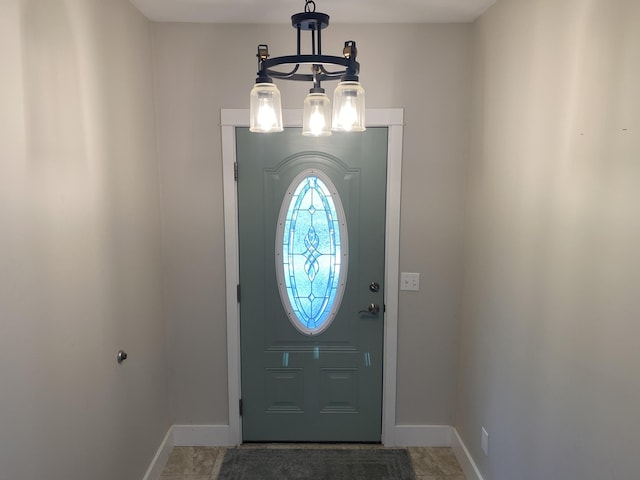 foyer entrance featuring a notable chandelier