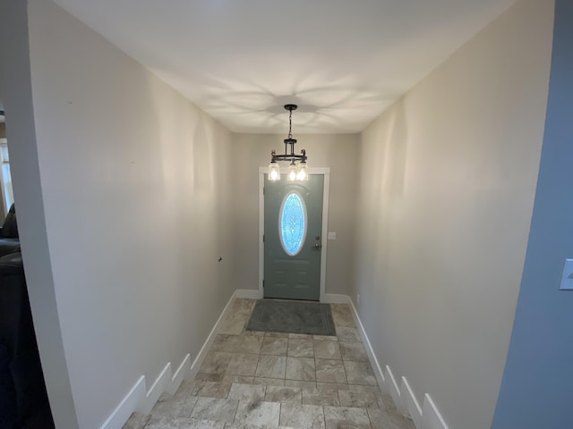 doorway to outside with a chandelier