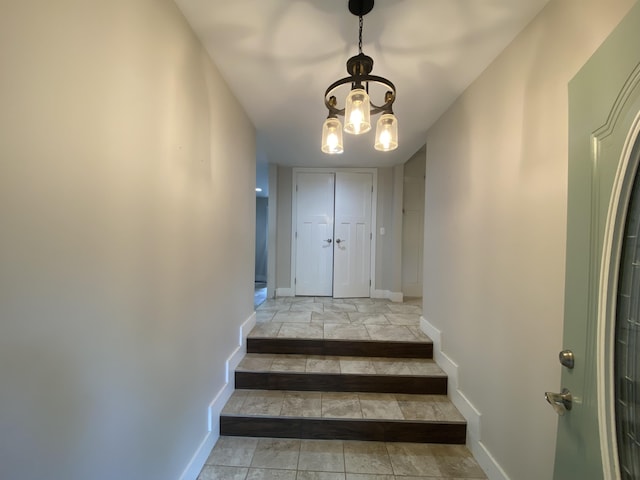 stairs featuring a notable chandelier and tile patterned floors