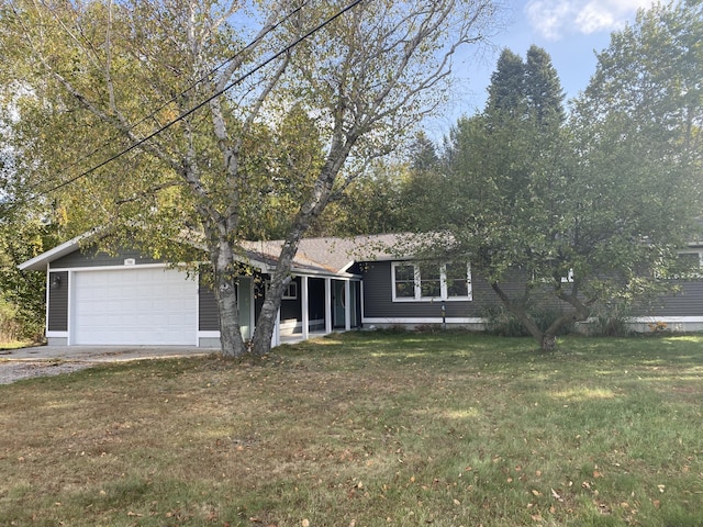 view of front of house featuring a garage and a front lawn