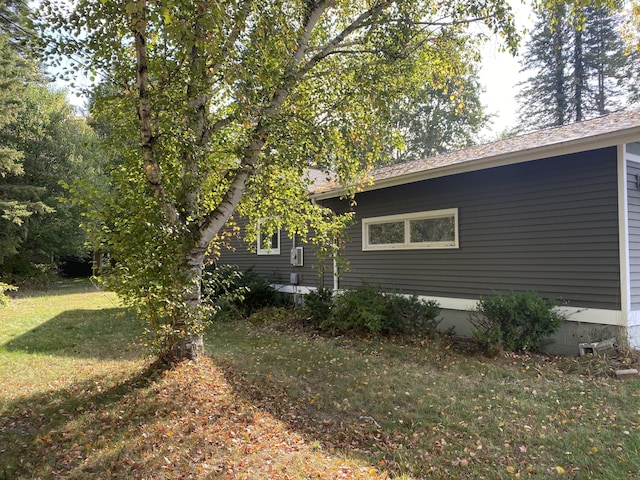 view of side of property with a yard