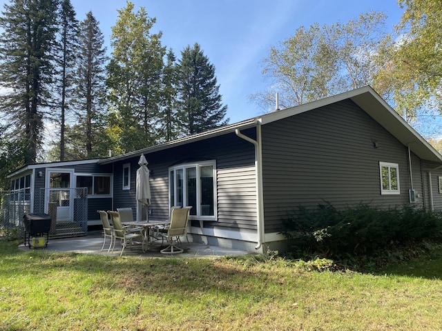 back of house featuring a yard and a patio area