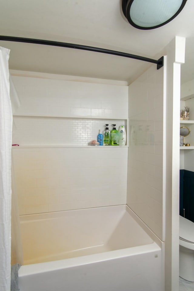 bathroom featuring shower / bathtub combination with curtain and toilet