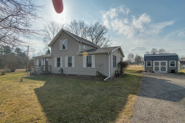 exterior space with an outbuilding and a front lawn