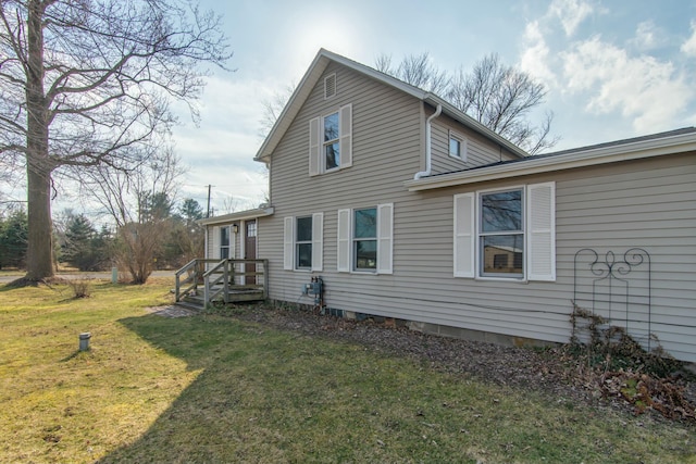 view of home's exterior with a lawn