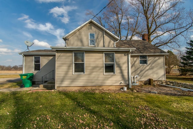 rear view of property with a lawn