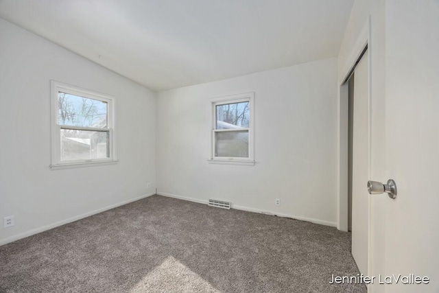 unfurnished bedroom featuring carpet floors and a closet