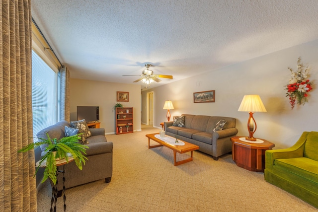 living room with a textured ceiling, light colored carpet, and ceiling fan