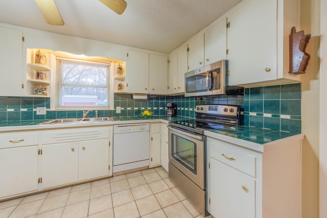 kitchen with white cabinetry, appliances with stainless steel finishes, sink, and tasteful backsplash