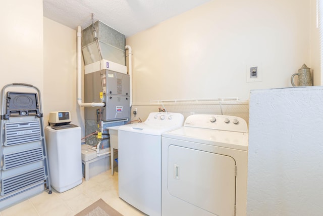 laundry room with washing machine and dryer and a textured ceiling