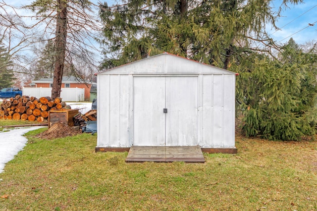 view of outbuilding with a lawn