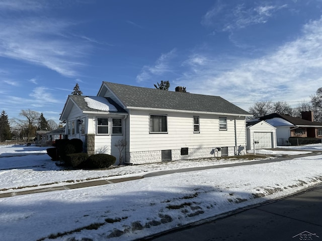 snow covered property featuring a garage