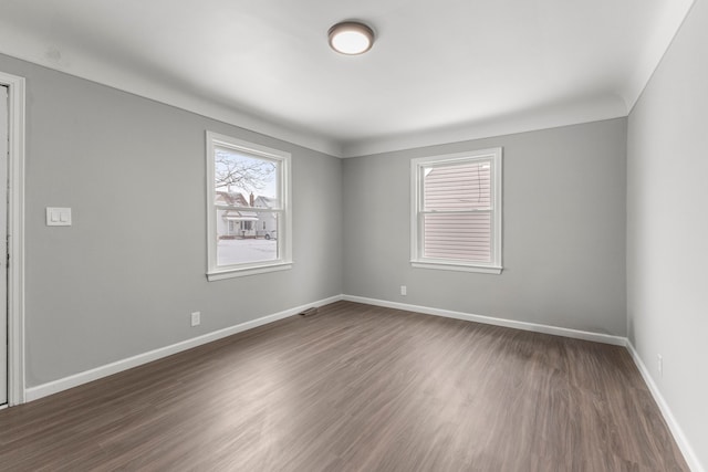 spare room featuring dark hardwood / wood-style flooring