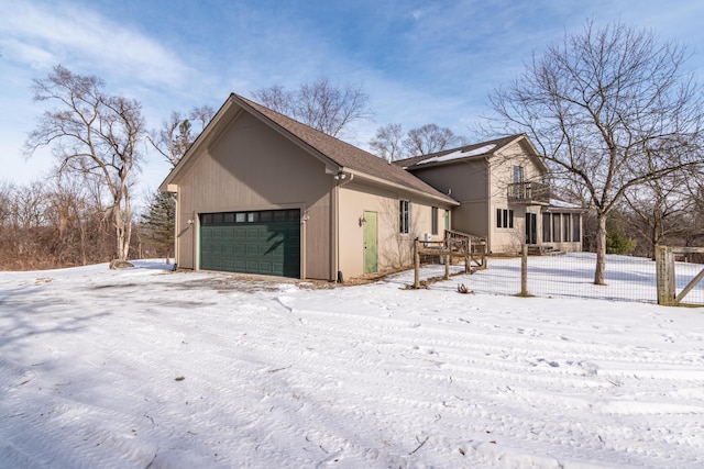 view of snowy exterior featuring a sunroom