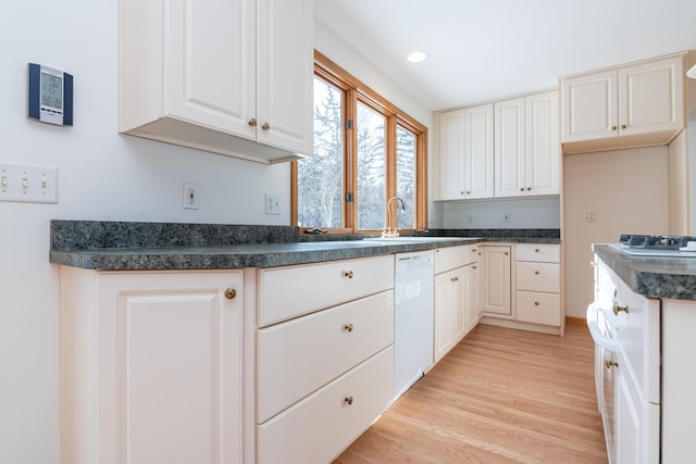 kitchen with white dishwasher, sink, light hardwood / wood-style flooring, and white cabinets