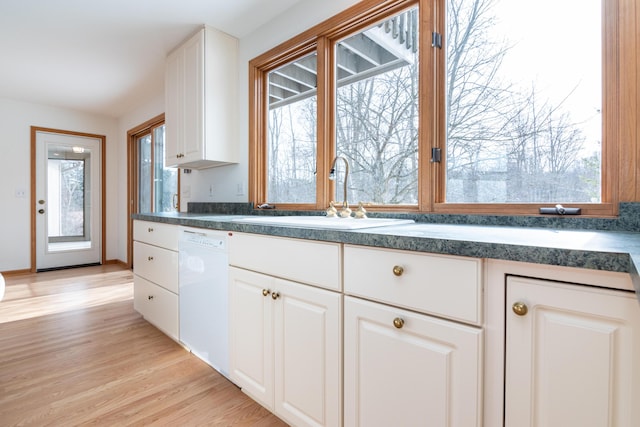 kitchen featuring white cabinetry, sink, light hardwood / wood-style flooring, and dishwasher