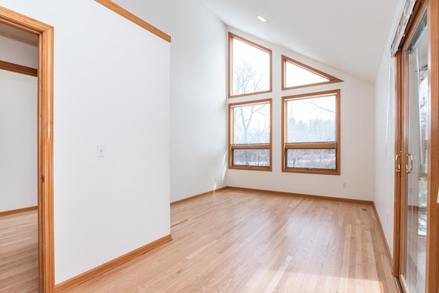 interior space featuring lofted ceiling and light hardwood / wood-style flooring