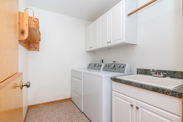 washroom featuring cabinets, sink, and washer and dryer