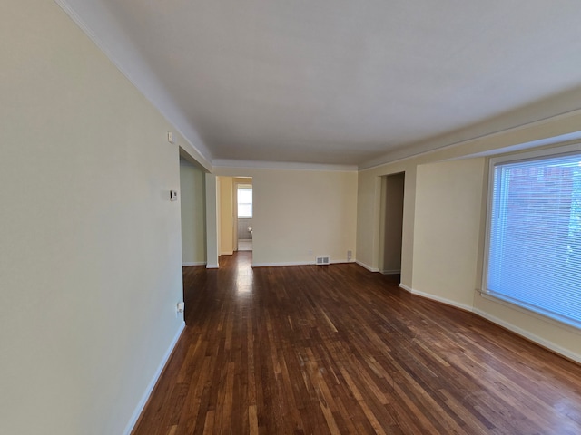 spare room featuring dark wood-type flooring