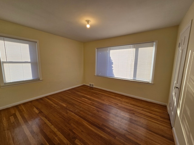 unfurnished bedroom featuring dark hardwood / wood-style floors and a closet