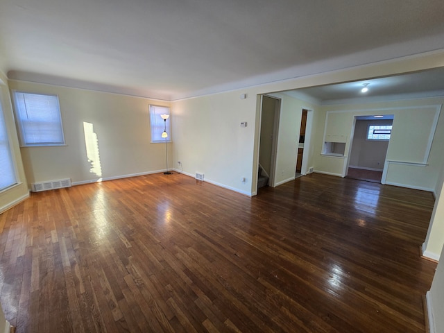 unfurnished room with dark wood-type flooring