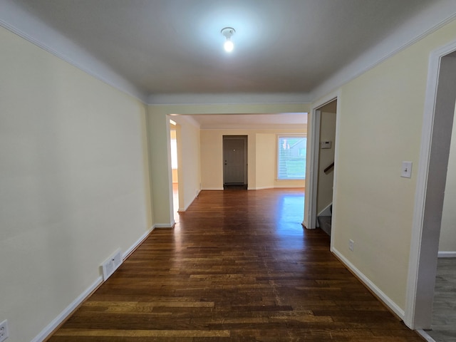 hallway with ornamental molding and dark hardwood / wood-style floors