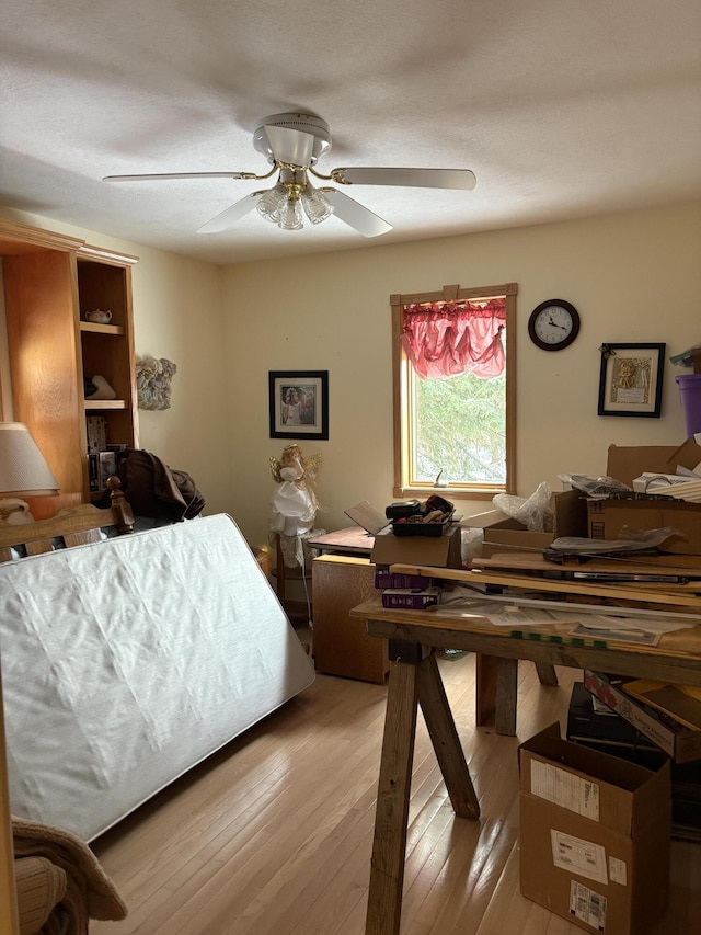 bedroom with ceiling fan and light hardwood / wood-style floors