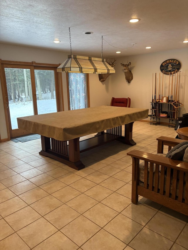 recreation room with light tile patterned floors and a textured ceiling