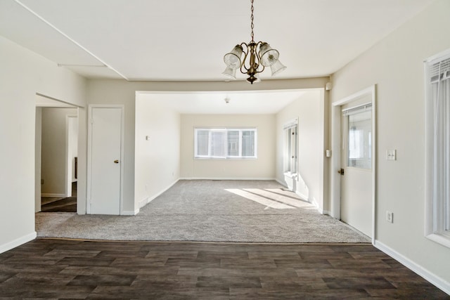 interior space with dark hardwood / wood-style floors and a notable chandelier