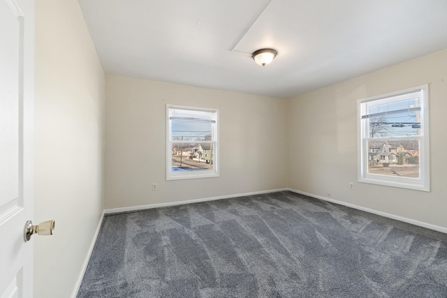 carpeted empty room featuring plenty of natural light