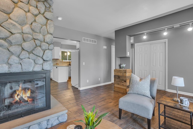 sitting room with dark hardwood / wood-style floors and a fireplace