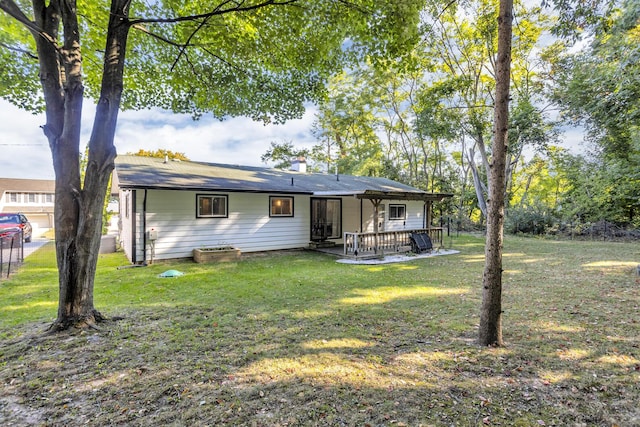 rear view of property with a yard