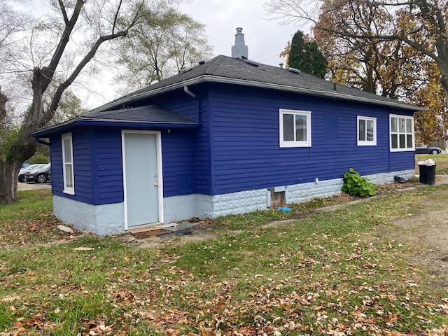 rear view of property featuring a yard