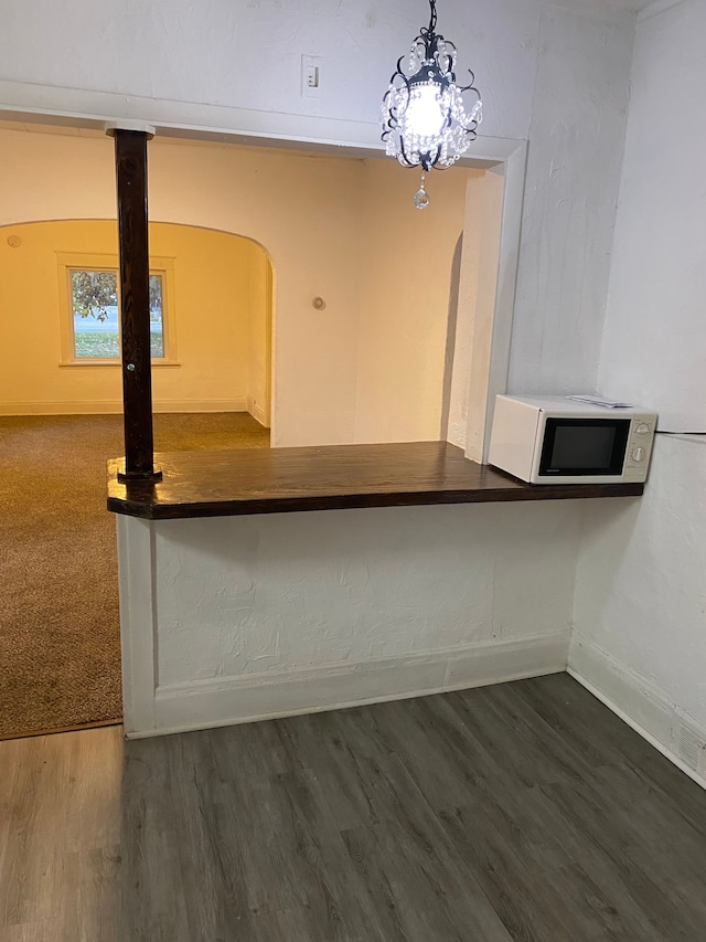 1192 S Belsay Rd, Burton, MI 48509 - unfurnished dining area featuring baseboards, arched walkways, and wood finished floors