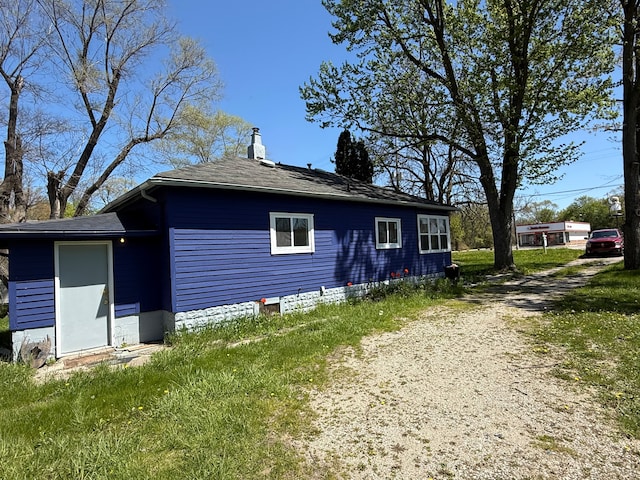 1192 S Belsay Rd, Burton, MI 48509 - back of property with a chimney and a shingled roof