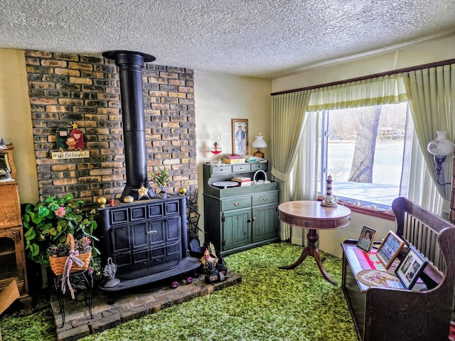 interior space featuring a wood stove, a textured ceiling, and carpet flooring