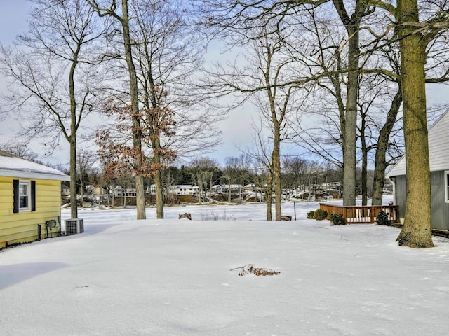 snowy yard with a wooden deck