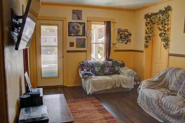 living room with ornamental molding and dark hardwood / wood-style floors