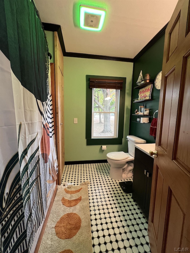 bathroom featuring vanity, ornamental molding, and toilet