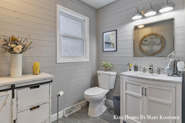 bathroom with vanity, toilet, and tile patterned flooring